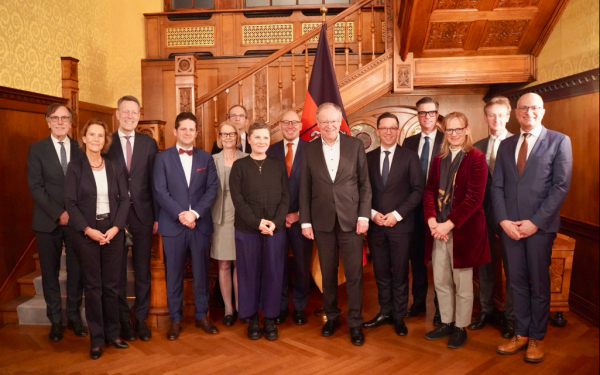 Menschen stehen vor einem Trppenhaus